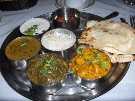 The vegetarian dinner with dal, vegetable korma, and palak paneer with side dishes